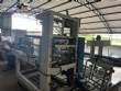 Automatic baling machine with shrink tunnel for bottles and jars in bales.