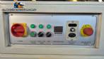 L-shaped packaging sealer with semi-automatic shrink tunnel.
