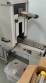 Label applicator machine with steam-operated shrink tunnel for sleeves.