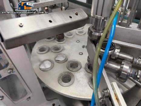 Tambflex Automatic rotary filling, dosing, and sealing machine for communion cups and small cups.