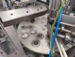 Tambflex Automatic rotary filling, dosing, and sealing machine for communion cups and small cups.