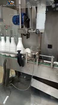 Labeling machine with steam sleeve tunnel and bottle baler