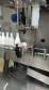 Labeling machine with steam sleeve tunnel and bottle baler