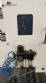 Labeling machine with steam sleeve tunnel and bottle baler
