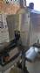 Labeling machine with steam sleeve tunnel and bottle baler