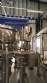 Zegla rotary filling machine with rinser and three-block capping system.