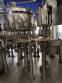 Zegla rotary filling machine with rinser and three-block capping system.