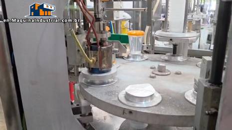 Rotary filling and dosing machine with capping and sealing unit for cups and bottles, capacity 2,000 units.